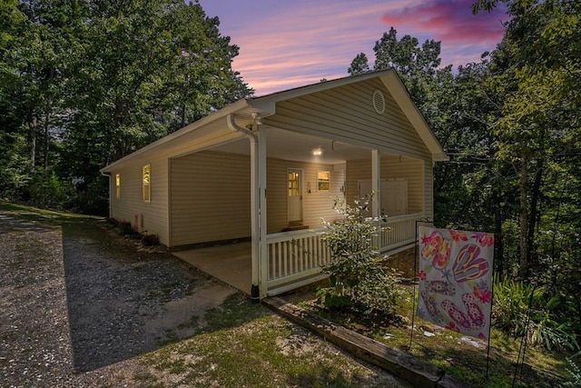 property exterior at dusk with covered porch