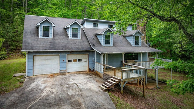 15.20 Piney Acres Rd, Blue Ridge, GA 30513 - view of front facade featuring covered porch, driveway, a garage, a chimney, and a forest view