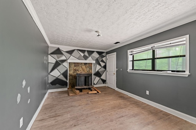 15.20 Piney Acres Rd, Blue Ridge, GA 30513 - interior space featuring ornamental molding, a textured ceiling, baseboards, wood finished floors, and a wood stove