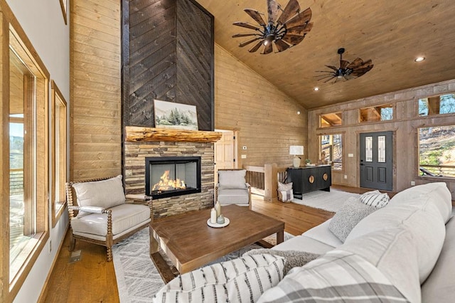 LOT11 Windy Valley Trl, Blue Ridge, GA 30513 - living room featuring high vaulted ceiling, wood finished floors, a stone fireplace, wood walls, and a ceiling fan