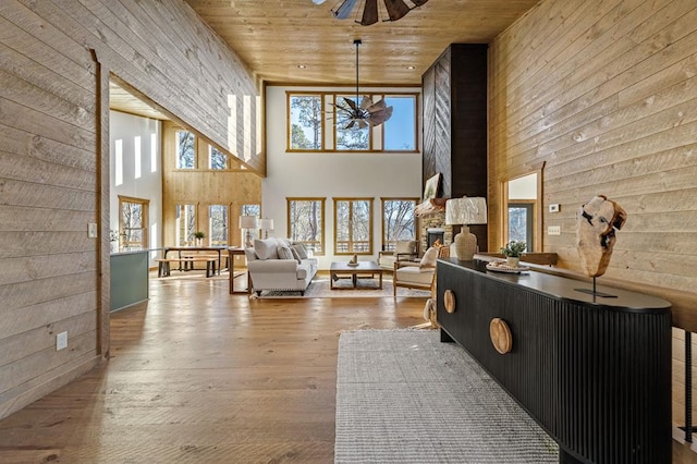 LOT11 Windy Valley Trl, Blue Ridge, GA 30513 - living room featuring a towering ceiling, ceiling fan, wooden ceiling, wooden walls, and hardwood / wood-style flooring