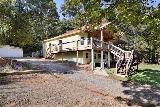 rear view of property featuring a lawn and a wooden deck