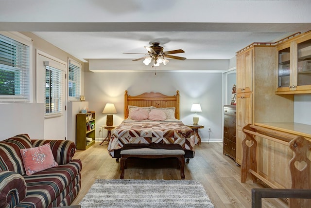 bedroom with ceiling fan and light hardwood / wood-style flooring