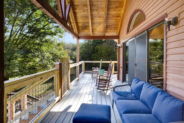 wooden terrace with an outdoor living space