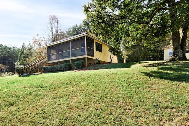 exterior space with a sunroom and a yard