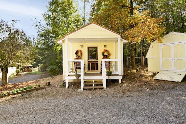 view of outdoor structure with covered porch