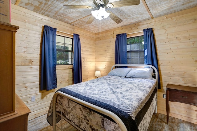 bedroom featuring wood walls, ceiling fan, wood ceiling, and wood-type flooring