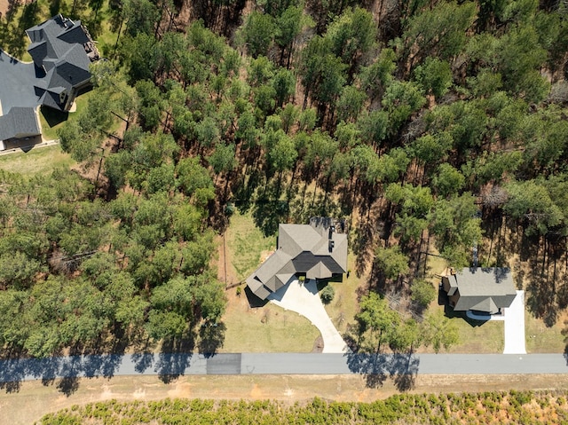 birds eye view of property with a wooded view