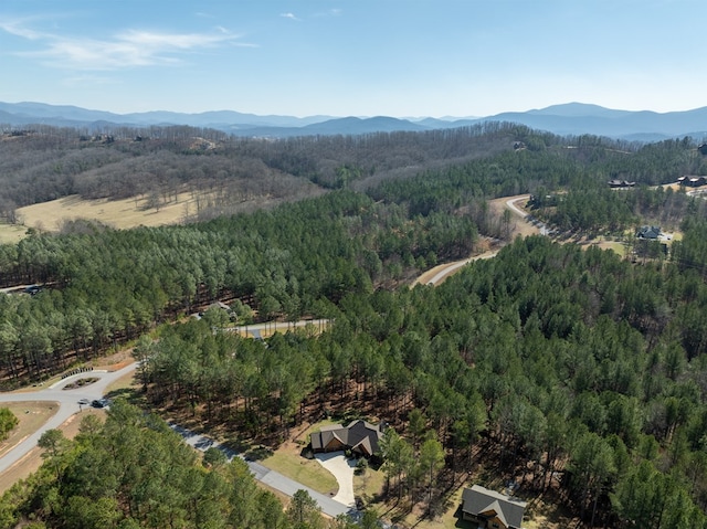 bird's eye view featuring a wooded view and a mountain view