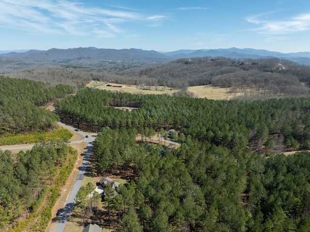 birds eye view of property featuring a mountain view and a wooded view