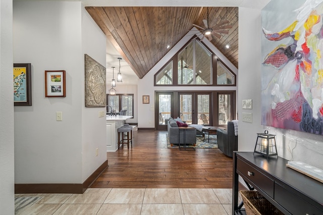 entryway with french doors, wood ceiling, wood finished floors, high vaulted ceiling, and baseboards