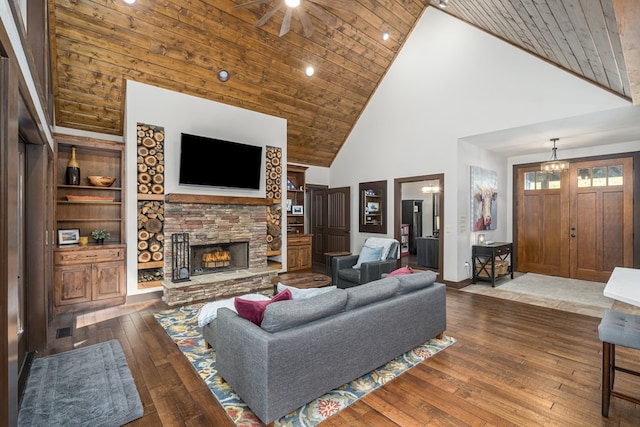 living area with built in features, a stone fireplace, high vaulted ceiling, wooden ceiling, and hardwood / wood-style flooring