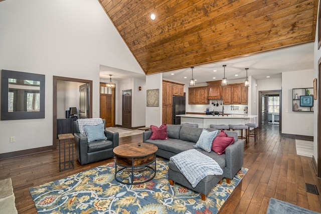 living area featuring dark wood-style floors, baseboards, visible vents, and high vaulted ceiling