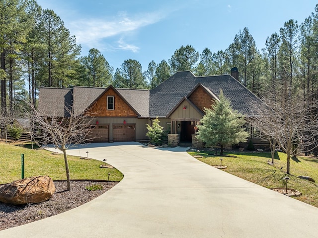 craftsman inspired home featuring board and batten siding, a front lawn, concrete driveway, roof with shingles, and an attached garage