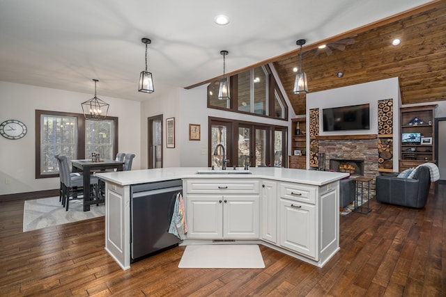 kitchen featuring a sink, white cabinetry, open floor plan, light countertops, and dishwasher