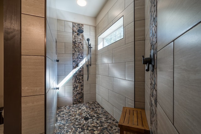 bathroom with a tile shower