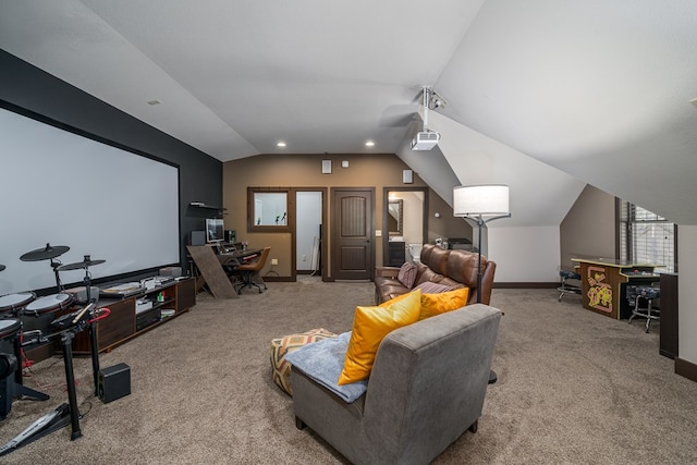 carpeted cinema room featuring vaulted ceiling and baseboards