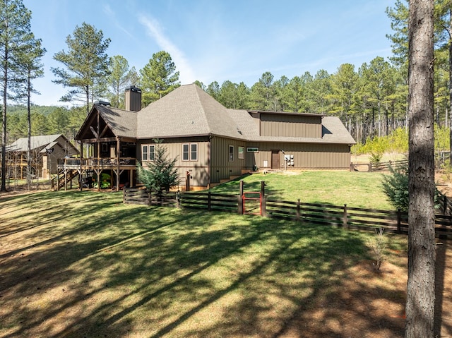 back of house with a chimney, stairway, a yard, fence, and a wooden deck