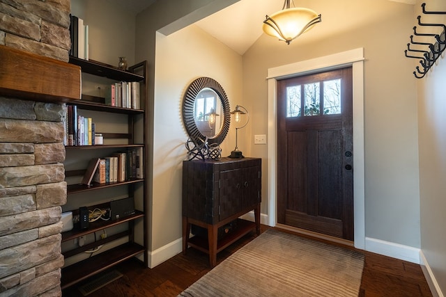 entryway featuring dark wood-type flooring and lofted ceiling