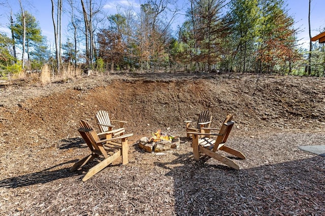 view of yard with a fire pit