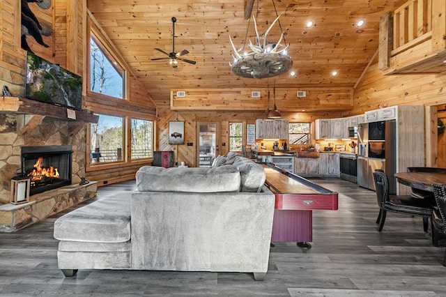 living room featuring wood ceiling, a fireplace, dark wood-type flooring, and wooden walls