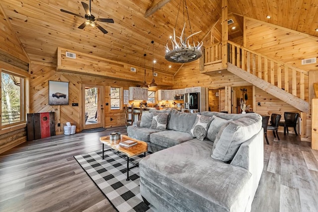 living room with hardwood / wood-style flooring, wood walls, and wooden ceiling