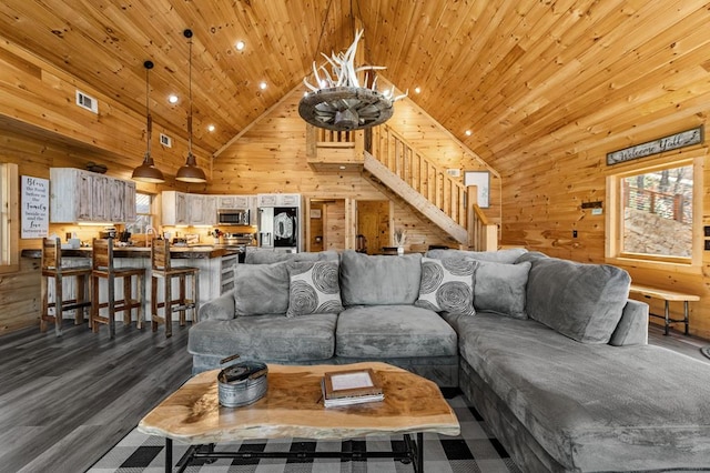 living room with hardwood / wood-style flooring, high vaulted ceiling, wooden ceiling, and wooden walls