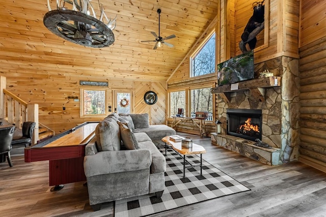 living room with a stone fireplace, high vaulted ceiling, wood-type flooring, ceiling fan, and wooden ceiling