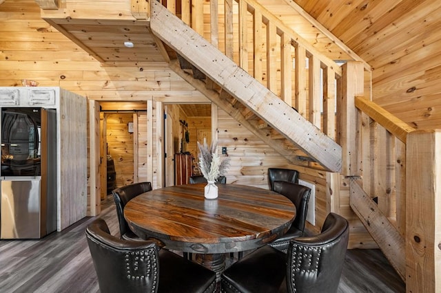 dining space featuring wood ceiling, wooden walls, and dark hardwood / wood-style floors