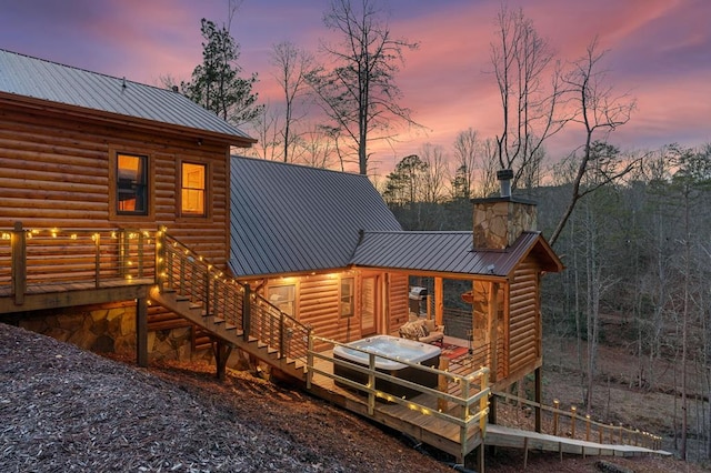 back house at dusk with a deck