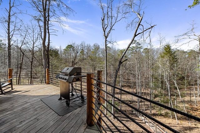 wooden deck featuring a grill