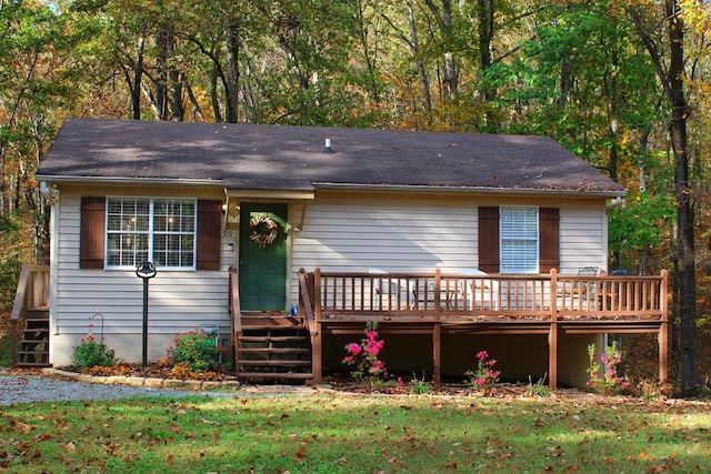 view of front of property with a front lawn and a wooden deck