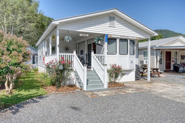 view of front of property with covered porch and cooling unit