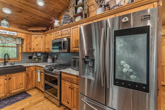 kitchen with light wood-type flooring, wooden ceiling, a sink, backsplash, and stainless steel appliances