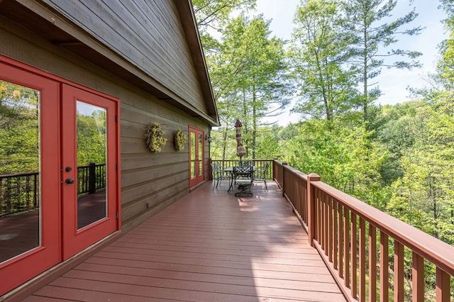 deck with outdoor dining area and french doors