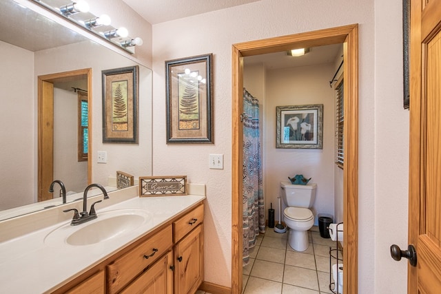 bathroom with vanity, tile patterned floors, and toilet