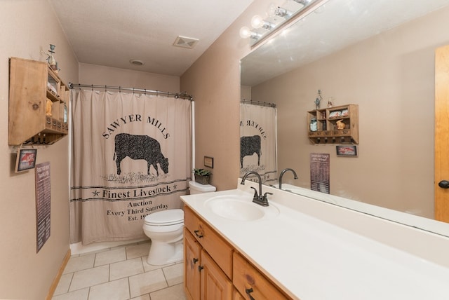 bathroom with visible vents, vanity, baseboards, tile patterned floors, and toilet