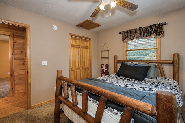 bedroom featuring baseboards, ceiling fan, carpet, and a closet
