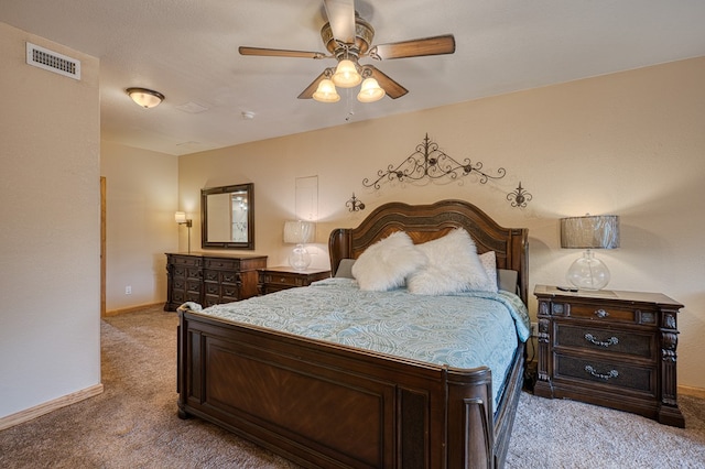 carpeted bedroom featuring visible vents, a ceiling fan, and baseboards