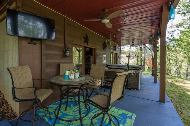 view of patio / terrace featuring ceiling fan and a hot tub