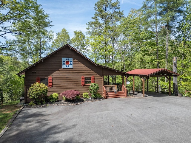 view of side of home with a carport