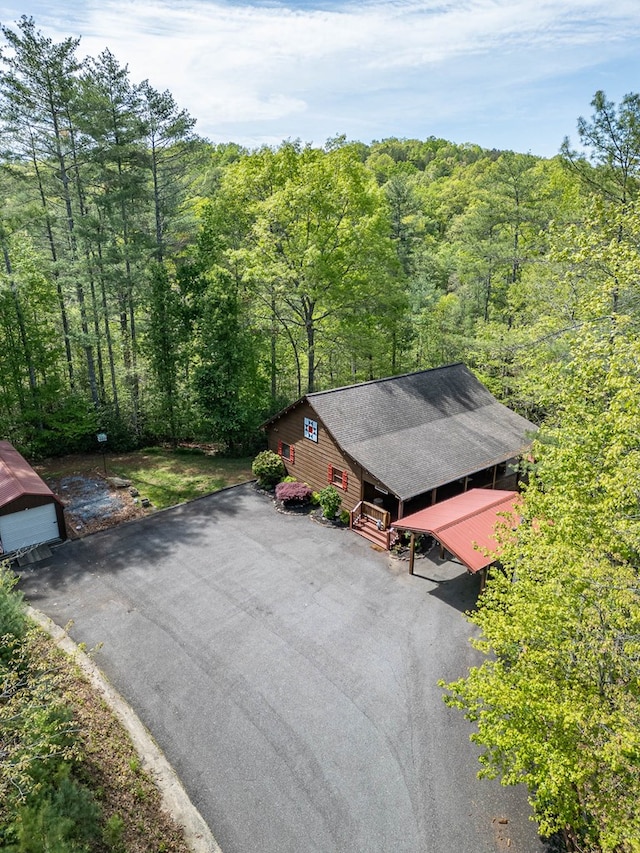 drone / aerial view with a wooded view