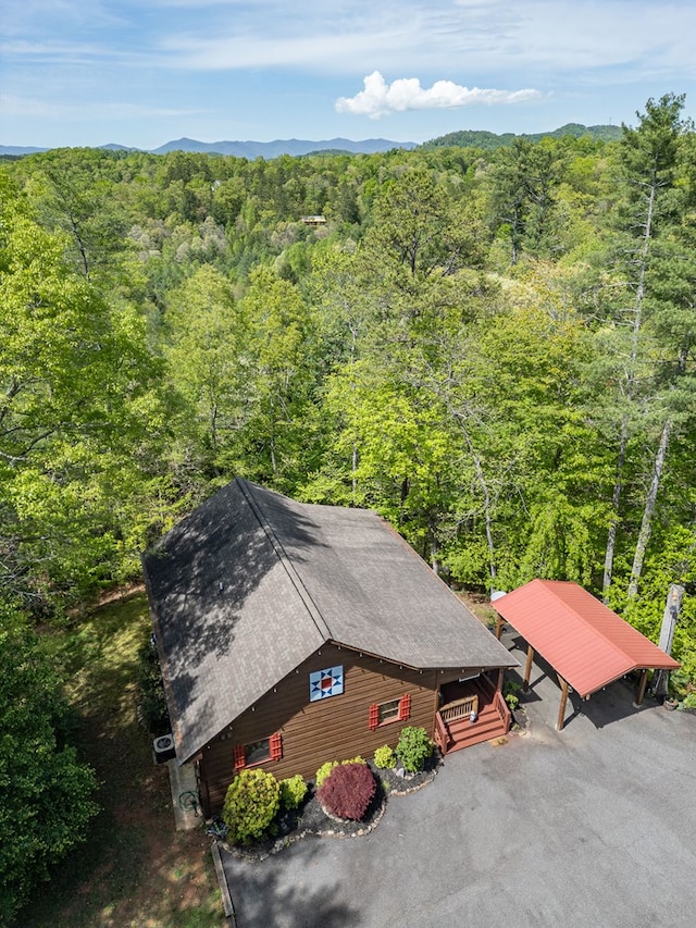 birds eye view of property with a forest view
