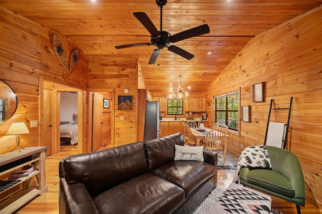 living room with vaulted ceiling, wood walls, sink, light hardwood / wood-style floors, and wood ceiling