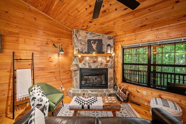 living room with a fireplace, wood walls, lofted ceiling, hardwood / wood-style flooring, and wooden ceiling