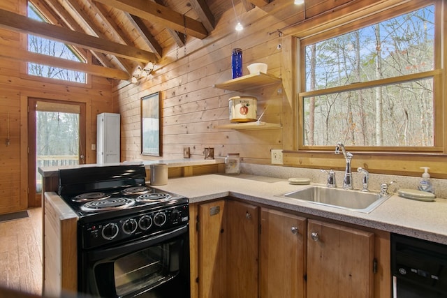 kitchen with sink, wood ceiling, wooden walls, black appliances, and lofted ceiling with beams