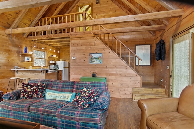 living room with beamed ceiling, wood ceiling, hardwood / wood-style floors, and wood walls