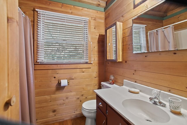 bathroom featuring vanity, a shower with shower curtain, toilet, and wood walls