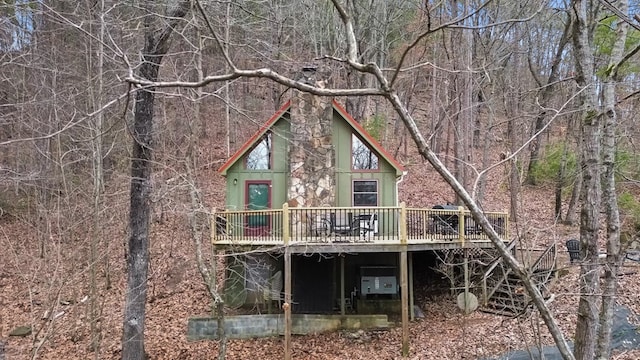 back of property with a wooden deck