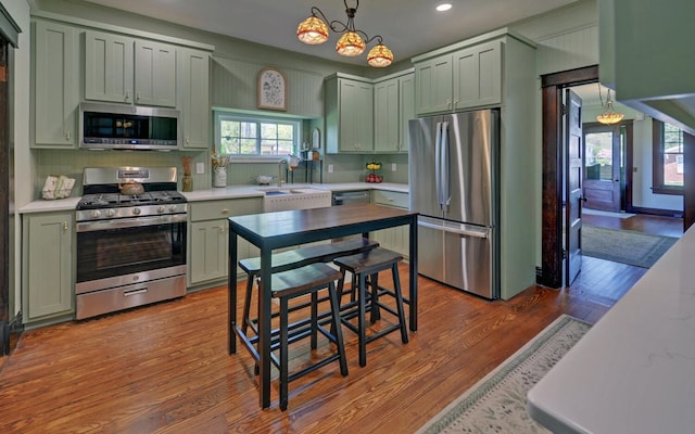 kitchen featuring light countertops, appliances with stainless steel finishes, an inviting chandelier, and recessed lighting